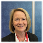 Headshot of Ann Gow, Deputy Chief Executive at HIS. Ann is standing against a blue background.