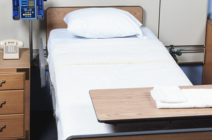 Image shows an empty hospital bed on a ward